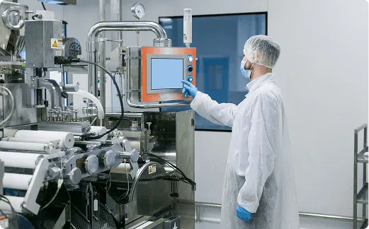 Factory operator monitoring industrial equipment to ensure safety compliance